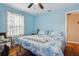 Comfortable bedroom with bright blue walls, wood floors, ample natural light, and a cozy atmosphere at 500 45Th S St, St Petersburg, FL 33711