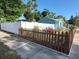 Charming home exterior with a decorative picket fence and a combination of white and brown fencing at 500 45Th S St, St Petersburg, FL 33711