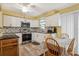 Bright kitchen with white cabinets, stainless steel appliances, and a cozy dining area with natural light at 500 45Th S St, St Petersburg, FL 33711