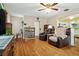 Cozy living room featuring hardwood floors, comfortable seating, ceiling fan and an open layout at 500 45Th S St, St Petersburg, FL 33711