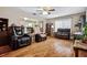 Cozy living room featuring hardwood floors, comfortable seating, ceiling fan and an open layout at 500 45Th S St, St Petersburg, FL 33711