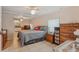 Spacious main bedroom with tiled floors, ceiling fans, and a view into the connected bathroom at 500 45Th S St, St Petersburg, FL 33711