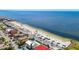 Sweeping aerial showcasing a beautiful gulf coast community with houses, beach, and parking area at 5623 Jobeth Dr, New Port Richey, FL 34652