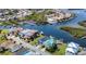 Scenic aerial view of waterfront neighborhood featuring colorful homes with boat docks and canal access at 5623 Jobeth Dr, New Port Richey, FL 34652