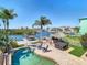Stunning aerial view of the pool, dock, and outdoor entertainment area on the waterfront property at 5623 Jobeth Dr, New Port Richey, FL 34652