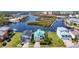 Aerial view showcasing a waterfront home with a teal roof and convenient access to canals and the bay at 5623 Jobeth Dr, New Port Richey, FL 34652