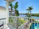 Balcony view of tropical landscaping, water, and pool at 5623 Jobeth Dr, New Port Richey, FL 34652