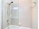 Tiled shower and tub with glass enclosure at 5623 Jobeth Dr, New Port Richey, FL 34652