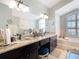 Luxurious bathroom with dual sinks, granite countertops, natural light, and modern fixtures at 5623 Jobeth Dr, New Port Richey, FL 34652