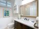 Stylish bathroom featuring a modern vanity, a framed mirror and soft, natural lighting at 5623 Jobeth Dr, New Port Richey, FL 34652