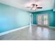 Bedroom with tiled floors, ceiling fan, and french doors at 5623 Jobeth Dr, New Port Richey, FL 34652