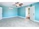 Bedroom with tiled floors, ceiling fan, and access to bathroom at 5623 Jobeth Dr, New Port Richey, FL 34652