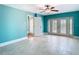 Bedroom with tiled floors, ceiling fan, and french doors at 5623 Jobeth Dr, New Port Richey, FL 34652