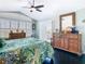 Bright bedroom with shutters, ceiling fan and deck access, creating a serene retreat at 5623 Jobeth Dr, New Port Richey, FL 34652