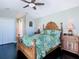 Comfortable bedroom featuring dark wood floors, a ceiling fan and a bright window at 5623 Jobeth Dr, New Port Richey, FL 34652