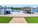 Private boat dock with lift access to the water, complemented by manicured lawn and brick pathway at 5623 Jobeth Dr, New Port Richey, FL 34652