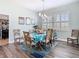 Dining area with seating for six features plantation shutters and decorative art at 5623 Jobeth Dr, New Port Richey, FL 34652