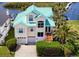 Charming two-story home features a striking turquoise roof, attached garage, and well-manicured landscaping at 5623 Jobeth Dr, New Port Richey, FL 34652