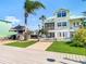 Large backyard with a tiki bar, grassy area, and waterfront access at 5623 Jobeth Dr, New Port Richey, FL 34652