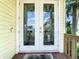 Front door with decorative etched glass and welcome mat and charming exterior at 5623 Jobeth Dr, New Port Richey, FL 34652