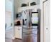 Close-up of kitchen featuring stainless steel refrigerator and built-in microwave at 5623 Jobeth Dr, New Port Richey, FL 34652