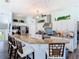 Bright kitchen featuring granite counters, stainless appliances, and eat-in bar with counter seating at 5623 Jobeth Dr, New Port Richey, FL 34652