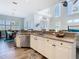 Open-concept kitchen offers white cabinetry and stainless steel appliances with countertop dining at 5623 Jobeth Dr, New Port Richey, FL 34652