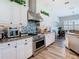 Well-lit kitchen features stainless steel appliances, granite countertops and white cabinets at 5623 Jobeth Dr, New Port Richey, FL 34652