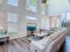 Spacious living room features shiplap walls, tall windows, and comfortable seating at 5623 Jobeth Dr, New Port Richey, FL 34652
