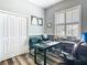 Practical office space with natural light, a sleek black desk, comfortable seating, and plenty of storage solutions at 5623 Jobeth Dr, New Port Richey, FL 34652
