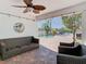 Relaxing covered patio with wicker furniture, string lights, and views of the canal and pool at 5623 Jobeth Dr, New Port Richey, FL 34652