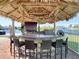Outdoor tiki bar featuring a covered bar with seating, views of the water, and plenty of space to relax at 5623 Jobeth Dr, New Port Richey, FL 34652
