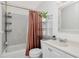 Bright bathroom featuring modern fixtures, white cabinetry, and shower-tub combo at 5850 21St N St # 12, St Petersburg, FL 33714