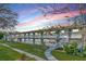 Charming two-story apartment building with a lush green lawn and beautiful landscaping at sunset at 5850 21St N St # 12, St Petersburg, FL 33714