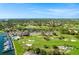 Aerial view showcasing the community's golf course, marina, pool, and lush landscaping at 5940 Pelican Bay S Plz # 1105, Gulfport, FL 33707