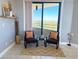Cozy sitting area on the balcony with comfortable chairs and a scenic view of the surrounding landscape at 5940 Pelican Bay S Plz # 1105, Gulfport, FL 33707