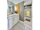 Cozy bathroom with single sink vanity with updated fixtures, a shower-tub combination, and modern wall accents at 5940 Pelican Bay S Plz # 1105, Gulfport, FL 33707