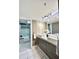 Modern bathroom with double sink vanity, decorative mirror, and walk-in shower at 5940 Pelican Bay S Plz # 1105, Gulfport, FL 33707
