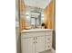 Close up of the bathroom sink vanity with updated fixtures, modern wall accents, and a decorative wall mirror at 5940 Pelican Bay S Plz # 1105, Gulfport, FL 33707