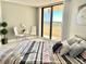 Bedroom featuring a comfortable bed and balcony access with stunning ocean views at 5940 Pelican Bay S Plz # 1105, Gulfport, FL 33707