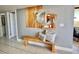 Hallway features tiled floors, wooden benches with pillows, and decorative mirror at 5940 Pelican Bay S Plz # 1105, Gulfport, FL 33707