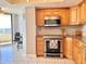 Bright kitchen features stainless steel appliances, granite countertops and tiled backsplash at 5940 Pelican Bay S Plz # 1105, Gulfport, FL 33707