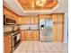 Bright kitchen with wooden cabinets, stainless steel appliances, and granite counters at 5940 Pelican Bay S Plz # 1105, Gulfport, FL 33707
