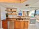 Stylish kitchen features stainless steel appliances, granite countertops, and island with seating at 5940 Pelican Bay S Plz # 1105, Gulfport, FL 33707
