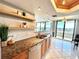 Kitchen sink with granite countertops, wood cabinetry and a beautiful view from the window at 5940 Pelican Bay S Plz # 1105, Gulfport, FL 33707