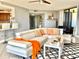 Comfortable living room featuring a large sectional sofa, sleek ceiling fan and sliding glass door access to balcony at 5940 Pelican Bay S Plz # 1105, Gulfport, FL 33707