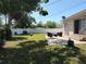 The backyard has a patio, outdoor seating, green lawn, and a privacy fence at 6221 13Th N Ave, St Petersburg, FL 33710