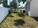 Large backyard enclosed by a white vinyl fence, perfect for outdoor activities at 6221 13Th N Ave, St Petersburg, FL 33710