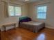 Bedroom with hardwood floors and natural light, featuring a bench and two windows at 6221 13Th N Ave, St Petersburg, FL 33710