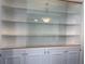 Stylish built-in shelves with glass sliding door and elegant pendant lighting above at 6221 13Th N Ave, St Petersburg, FL 33710